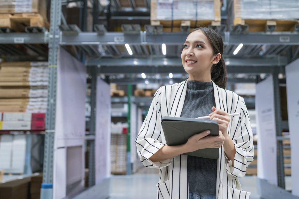 woman in warehouse using tablet for digital transformation projects