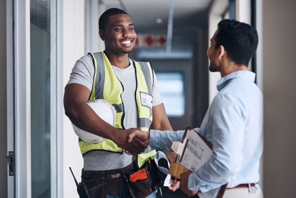 A warehouse manager greets one of his world-class suppliers in an effort to develop good supplier relationships